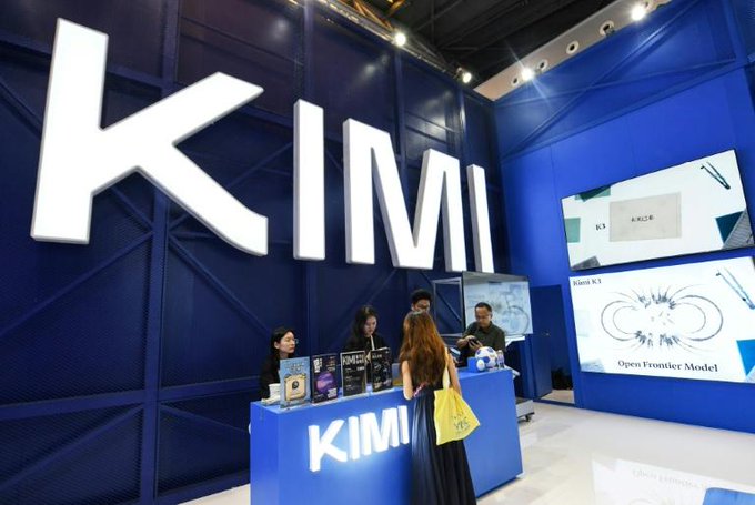 A Kimi AI booth at a technology exhibition displays the company's "Kimi K3" model as the "Open Frontier Model," with staff assisting visitors at a branded counter. The image relates to the post by illustrating Kimi's AI technology, which is among the tools used by the Bitcoin Red Team to audit open-source projects for bugs.