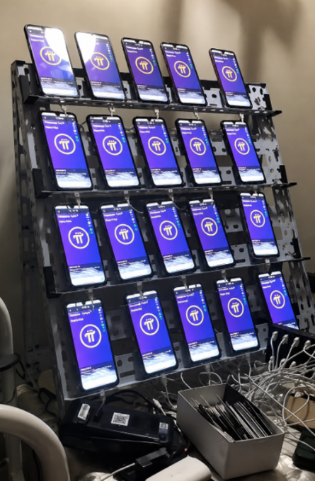 A multi-tiered rack holds roughly 24 smartphones, all displaying the Pi Network app with its distinctive "π" logo on a purple background. The image illustrates the post's cautionary message about miners who deploy numerous devices to accumulate Pi, emphasizing that security and account protection matter more than sheer mining volume.