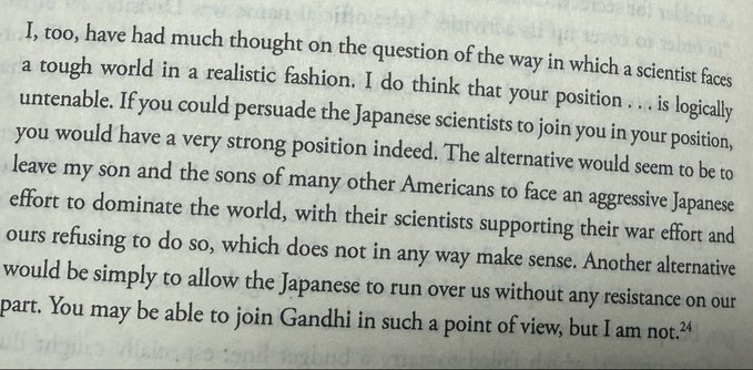 A close-up of a book page with a paragraph discussing a scientist's ethical dilemma regarding Japanese war efforts and the alternatives presented to American scientists.