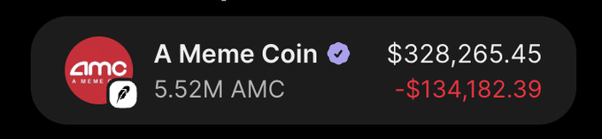 The image shows a wallet display for "A Meme Coin" with a verified checkmark, holding 5.52M AMC tokens valued at $328,265.45, showing a loss of $134,182.39 in red. This appears to relate to the post by showcasing a meme coin portfolio with significant unrealized losses despite holding a large amount of AMC tokens.