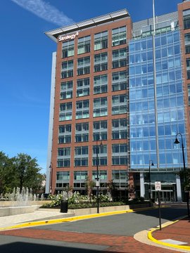 A multi-story building with red brick and large glass windows displays the signage 'discovery' at the top.