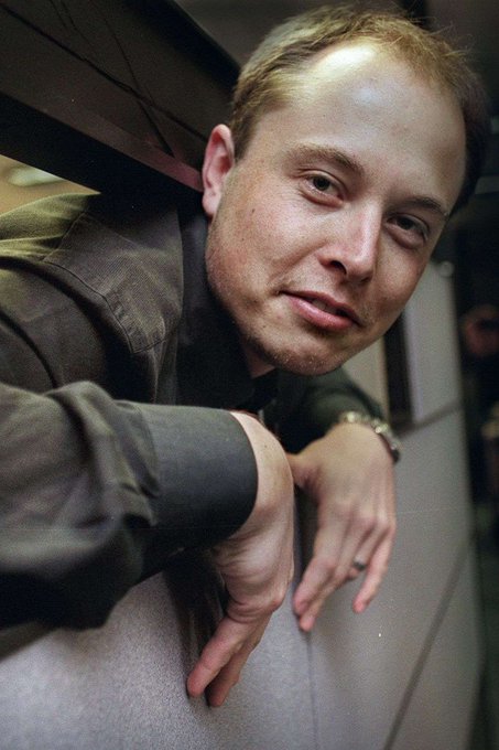 A photograph of a man with short blonde hair wearing a dark jacket.