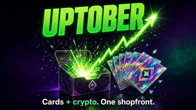 An advertisement featuring the word 'UPTOBER' in bright green letters with an open box of glowing cards, and the text 'Cards + crypto. One shopfront.'