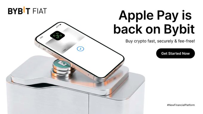 The image features a white iPhone with an app called "Apple Pay" displayed on its screen, along with some text that reads "Bybit Pay is back on Bybit", indicating that the app has been updated or reinstalled. The phone is placed on top of a metal box, and there are two coins visible in the image - one at the bottom left corner and another near the center right side of the phone.