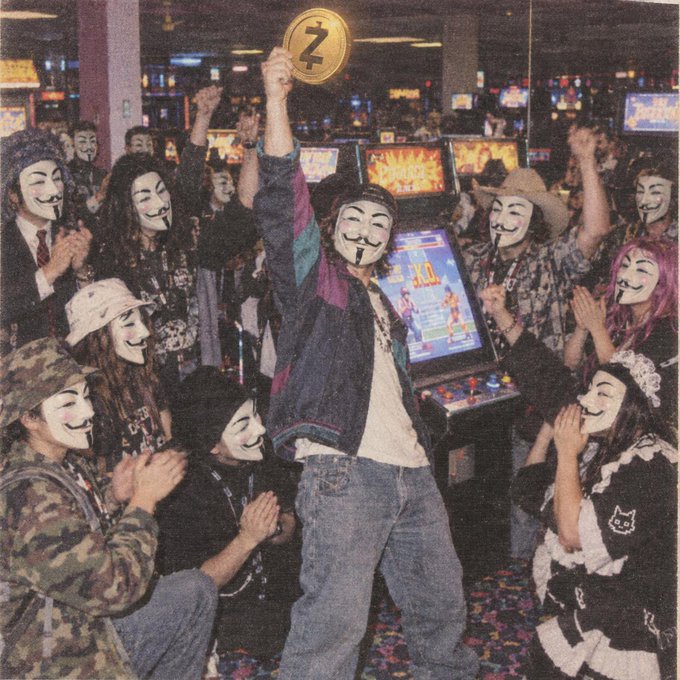 A retro arcade scene showing a crowd of people wearing Guy Fawkes (V for Vendetta) masks cheering around an arcade cabinet, with one person in the center holding up a Zcash (Z) coin.