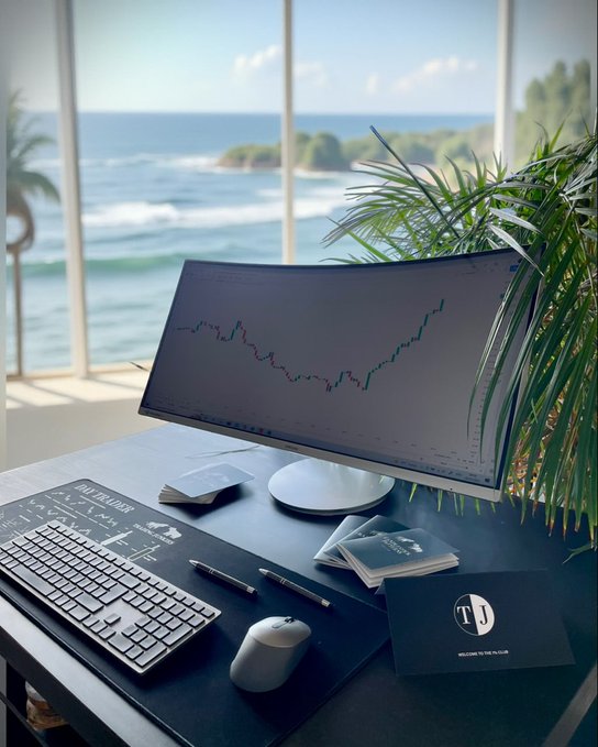 In the image, a computer monitor is displaying stock market charts against a window overlooking the ocean. Below the monitor, there's a black laptop and a white mouse that are part of the workstation setup. The stock market chart shows upward-moving numbers, indicating potential growth in trading activities during the period shown. The post emphasizes the significance of understanding the evolving trading landscape and how it affects businesses such as @useTria adoption. It also highlights the importance of staying updated on changing metrics like active wallets, volume, and transactions to better understand the market trends.