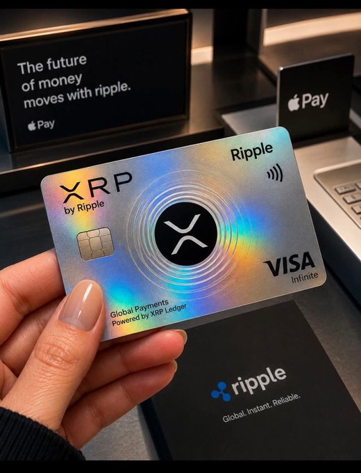 A hand holding a holographic Ripple/XRP Visa Infinite credit card with text reading 'The future of money moves with ripple' and 'Apple Pay' signage visible in the background.