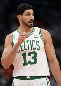 This image shows Enes Kanter, a basketball player wearing a Boston Celtics jersey with the number 13 and "Vistaprint" logo. The post suggests he might be a candidate for the WNBA draft, which is unusual given he is a male NBA player.