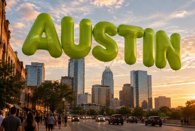 AUSTIN — Giant inflatable green letters spelling "AUSTIN" float above a busy downtown street at sunset, with the city's skyline of skyscrapers and historic buildings bathed in golden light as pedestrians stroll and traffic moves below. The bold, balloon-like letters mirror the meme's "$Grass" caption, visually representing the phrase as a literal display of text hovering over the urban landscape.