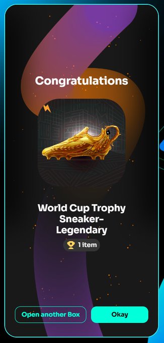 A digital reward screen displaying 'Congratulations' for obtaining a 'World Cup Trophy Sneaker-Legendary' item, featuring a golden soccer cleat against a dark background with options to 'Open another Box' or 'Okay'.