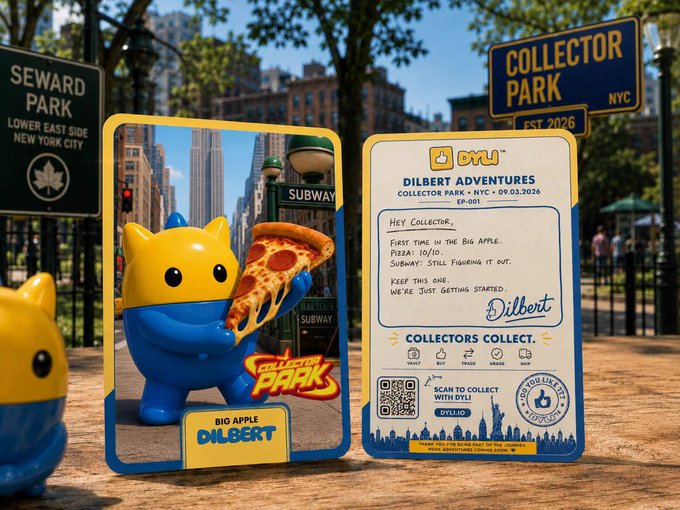 A promotional display in Seward Park featuring 'DYLIB' collectible cards, including one showing a yellow and blue character holding pizza labeled 'BIG APPLE DILBERT' and another reading 'DILBERT ADVENTURES, COLLECTOR PARK • NYC • 09.03.2026, EP-001'.