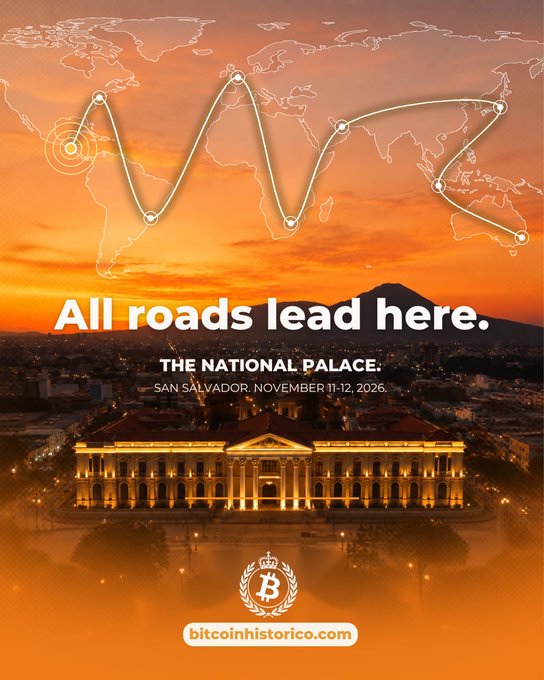 A promotional image for "bitcoinhistorico.com" shows a sunset skyline of San Salvador featuring the illuminated National Palace, overlaid with a glowing world map connecting global points to the location. Bold white text reads "All roads lead here," with smaller text specifying "THE NATIONAL PALACE. SAN SALVADOR. NOVEMBER 11-12, 2026," reinforcing the post's invitation to gather in El Salvador for a Bitcoin-centered event.