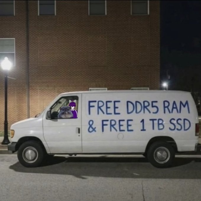 A white van is parked at night with hand-painted blue text on the side reading 'FREE DDR5 RAM & FREE 1TB SSD'.
