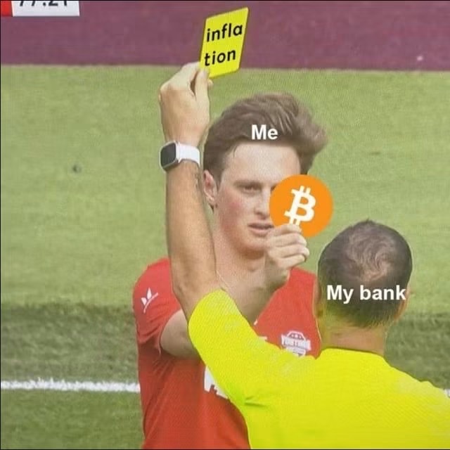 A soccer referee holds up a yellow "inflation" card on a player labeled "Me," who covers his face with a Bitcoin symbol, while the referee is labeled "My bank"—picturing the joke of "Reverse Uno," where banks issue inflationary penalties that disadvantage Bitcoin holders.