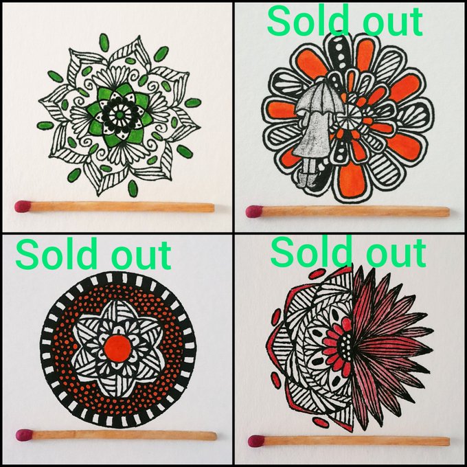 Four mandala-style drawings displayed in a grid with matches at the bottom; three are marked "Sold out" while only the top-left green and black floral design remains available.