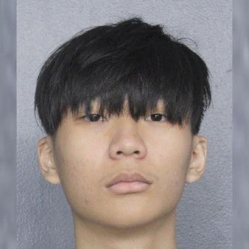 A mugshot-style photo shows a young Asian man with dark hair and a neutral expression against a plain gray background, accompanying a post about 22-year-old Malone Lam pleading guilty to stealing $245 million in Bitcoin to fund a lavish lifestyle.