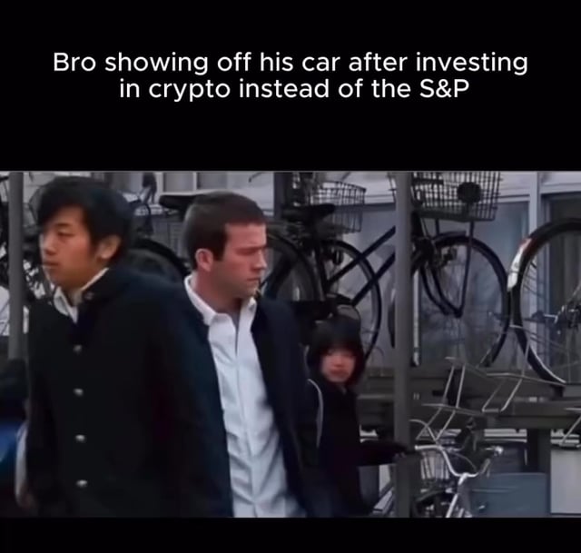 The image shows a man walking down the street, with several bicycles parked nearby. In the background of the photo, there are two people standing next to each other, one wearing a white shirt and the other dressed in black. The text "Bro showing off his car after investing in crypto instead of the S&P" is also present in the image.