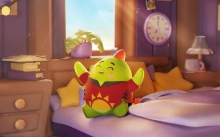A small green animated character wearing a red outfit with a yellow sun design sits on a bed in a cozy purple bedroom with a clock showing approximately 4:00.