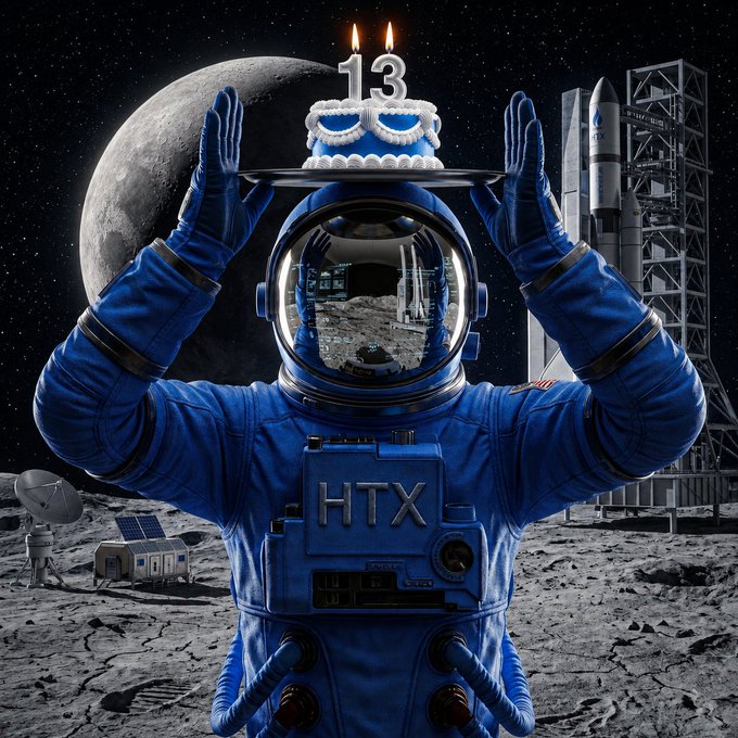 An astronaut in a blue "HTX" spacesuit holds a birthday cake with "13" candles on a lunar landscape, with a rocket in the background. The image celebrates HTX's 13th anniversary, matching the post's #HTX13thAnniversary theme and the celebratory giveaway announcement.