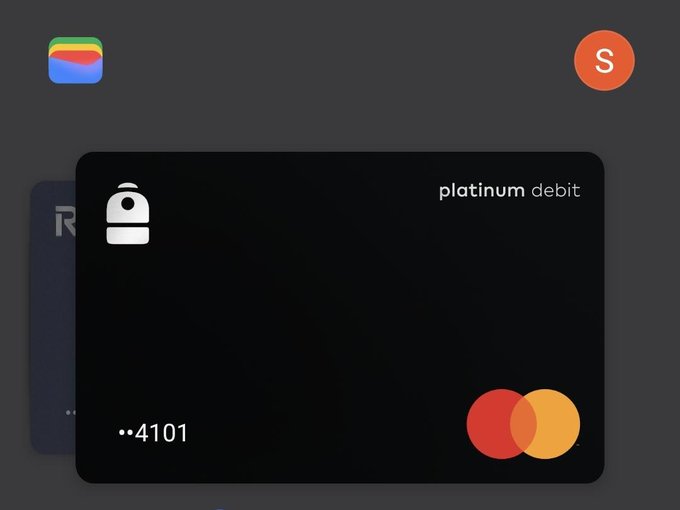 A mobile app screen displaying a black 'platinum debit' card ending in 4101 with a Mastercard logo, set against a dark interface with app icons in the corners.