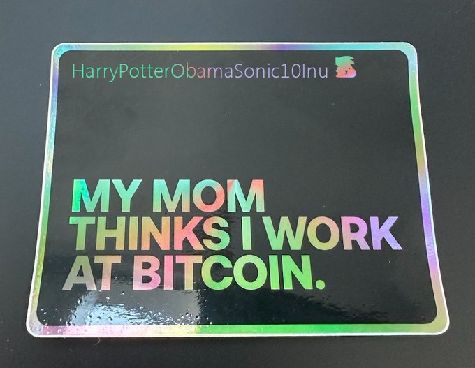 A holographic sticker reading 'HarryPotterObamaSonic10Inu' and 'MY MOM THINKS I WORK AT BITCOIN.'