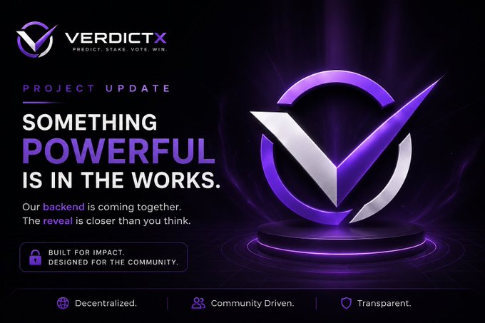 A promotional graphic for VerdictX featuring a large 3D purple and silver checkmark logo on a dark background, with text reading 'PROJECT UPDATE', 'SOMETHING POWERFUL IS IN THE WORKS', and 'Our backend is coming together. The reveal is closer than you think.', along with the tagline 'PREDICT. STAKE. VOTE. WIN.'