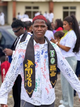 A young man wearing a red cap and a white shirt covered in signatures celebrates graduating, as reflected in the post about finishing his final year exams; his black scarf prominently displays "2026" in gold lettering, indicating his graduation year.