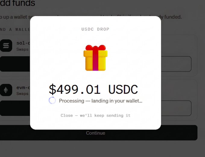 A digital interface showing a USDC drop notification of $499.01 USDC with a gift box icon and the message 'Processing — landing in your wallet... Close - we'll keep sending it' over a dark wallet background.