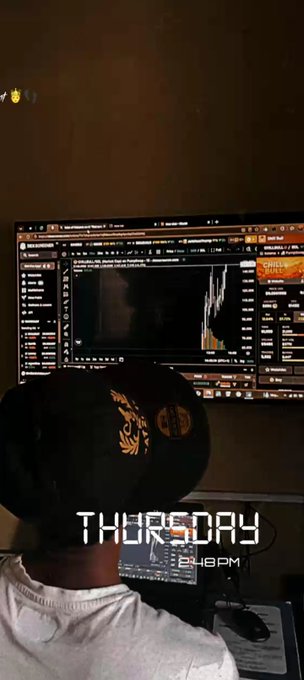 A person wearing headphones works in a dimly lit room in front of a large monitor displaying audio editing software with waveforms. The text 'THURSDAY' and '8:48PM' is overlaid on the image.