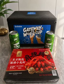 A still life arrangement on a counter featuring a black 'Ogate Gateway World Cup' cooler box, two green 'SP' Sprite cans, and a red package of spicy crawfish tails with Chinese characters.