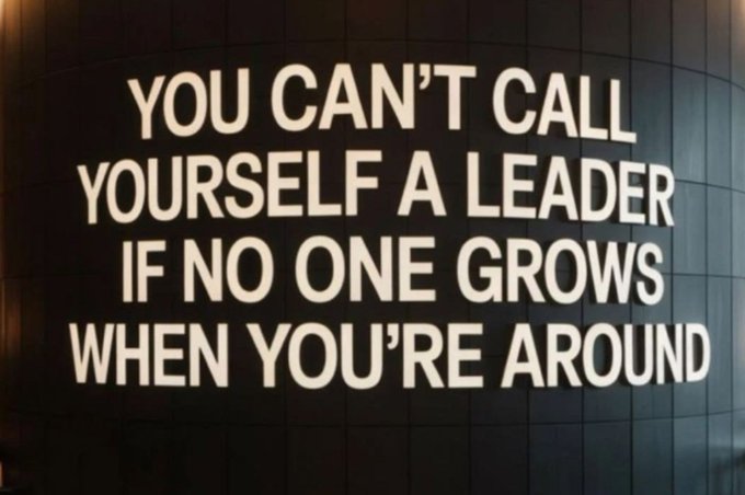 Text on a dark tiled wall reading 'YOU CAN'T CALL YOURSELF A LEADER IF NO ONE GROWS WHEN YOU'RE AROUND'.