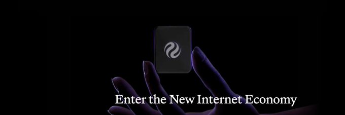 A promotional image showing hands holding a small dark device with a logo, accompanied by the text 'Enter the New Internet Economy' against a black background.