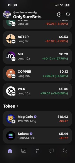 The image shows a close-up of an iPhone screen, with several icons displayed on the home screen. A screenshot of a trading app's page, showing a list of various cryptocurrencies along with their values, can be seen. There are descriptions for each coin such as "copper", "long long", and "sell all". The post says, "wld is scared and maybe from scammers now overtook Sell all". This could imply that the user's crypto investments have been affected by some sort of scam or market manipulation related to a particular cryptocurrency.