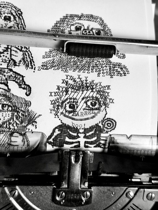 A black-and-white image shows a typewriter creating ASCII art of a skeleton and the word 'BARREL' and 'boo!' on the paper.