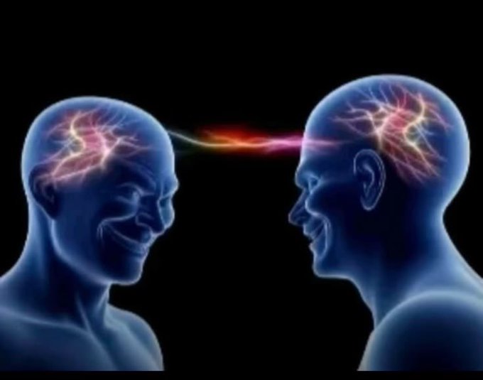 An illustration depicts two transparent blue human heads facing each other with glowing neural activity inside, connected by a vibrant, colorful energy stream representing thought or communication.