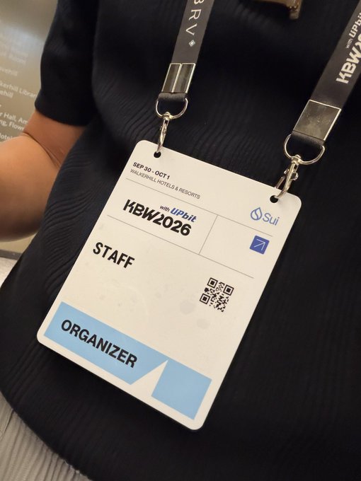 A conference badge on a lanyard reads 'SEP 30 - OCT 1, HBW2026 with UPbit, STAFF, ORGANIZER' featuring Sui branding and a QR code.