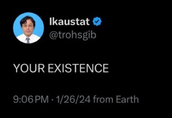 A tweet screenshot from user @trohsgib with the profile name "Ikaustat" showing a verified badge and profile photo of a man in a suit. Posted at 9:06 PM on 1/26/24 from Earth, the tweet simply reads "YOUR EXISTENCE," which aligns with the accompanying post's message that existence will be transformed overnight due to XRP.