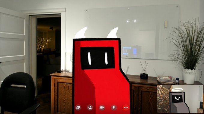 A red arcade cabinet mascot with white horns is displayed via video call, matching the playful theme of the loading bar shown as 90% complete in the post.