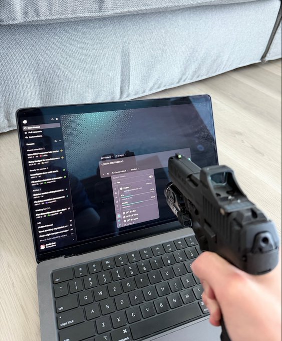 A hand points a pistol at a laptop screen displaying a chat interface and game settings menu (showing options like "Auto Run," "Single Set"), humorously threatening the software to perform better, which fits the caption's "capy v2 better lock in and ship itself" theme of pressuring the program to improve.