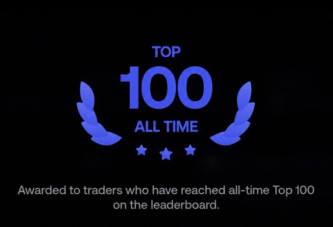 A "TOP 100 ALL TIME" achievement badge in blue, featuring laurel wreaths and three stars, displayed on a black background with the caption "Awarded to traders who have reached all-time Top 100 on the leaderboard." The image relates to the post as it represents the prestigious trading milestone the user aspires to achieve, known for triggering FOMO among competitive traders.