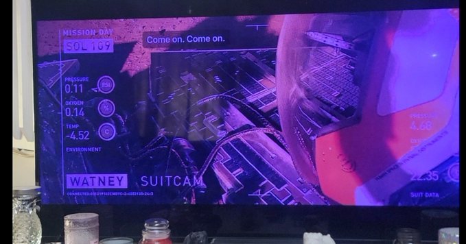 A TV screen displays a "SUITCAM" feed labeled "WATNEY" showing mission data on SOL 109, including pressure (0.11), oxygen (0.14), temperature (-4.52), and a "Come on. Come on." text overlay as the figure appears to work on equipment. The "Things turn around on SOL 109" caption suggests a pivotal moment in the astronaut Watney's struggle to survive on Mars.