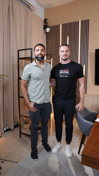 Two men pose together in a modern studio setting, with the man on the right wearing a black t-shirt that reads "WHEN SH*T HAPPENS #Bitvising." The image accompanies a post announcing a lengthy conversation with Tushar Jain, Co-Founder of Multicoin Capital, who appears to be one of the individuals pictured.