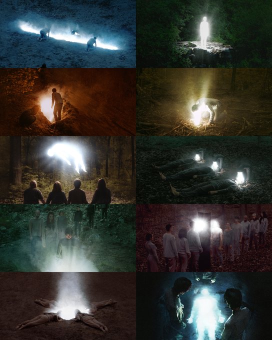 A grid of dark, ethereal photographs from the "Lumans" series, featuring glowing humanoid figures emerging from natural forest settings—standing, kneeling, lying among fallen logs, or encircling a central luminous form—creating a haunting contrast between radiant light and shadowy woodland environments.