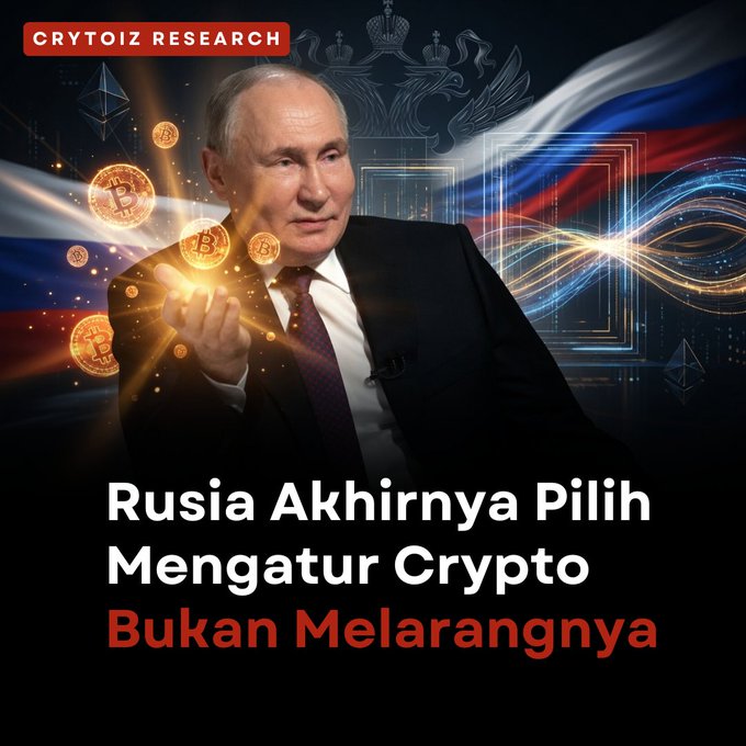 The image features Vladimir Putin holding a glowing light surrounded by Bitcoin coins, with the headline "Rusia Akhirnya Pilih Mengatur Crypto Bukan Melarangnya" (Russia finally chooses to regulate Crypto, Not banning it).