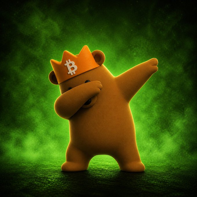 The image features a cartoon bear wearing an orange crown, which has the word "bitcoin" written on it. The bear appears to be dancing or doing the hokey pokey, with its arms raised up in the air. The background of the image is green and filled with smoke, creating a surreal atmosphere that complements the whimsical nature of the cartoon bear's outfit and actions.