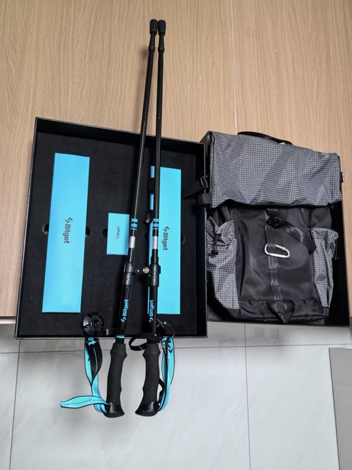 A Sougayilang fishing rod and reel combo with a backpack is laid out in its black presentation box on a tiled floor.