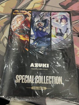 A sealed "Azuki Trading Card Game Special Collection Vol. 1" package featuring artwork of three anime-style characters, displayed alongside a social media post offering a cash bonus plus a free $50 AA card for anyone who purchases it at the Azuki Booth (WH-424) during Anime Expo.