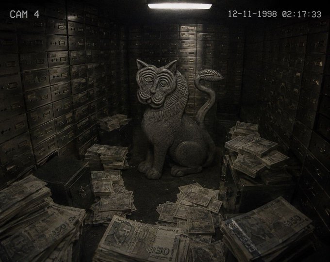 A dark, grainy security camera still labeled 'CAM 4' dated '12-11-1998 02:17:33', depicting a stone cat statue sitting amidst scattered stacks of cash and surrounded by rows of safety deposit boxes.