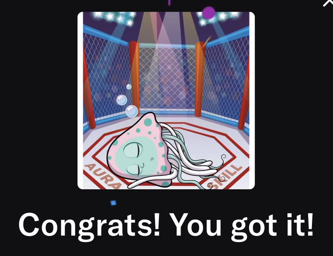 A small, light blue axolotl-like creature with long hair and closed eyes lies in an MMA octagon setting, with the text 'Congrats! You got it!' displayed below.