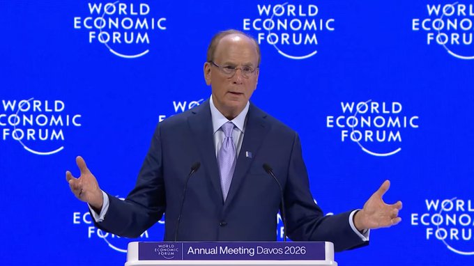Larry Fink, CEO of BlackRock, delivers remarks at a podium labeled "Annual Meeting Davos 2026" against a backdrop of World Economic Forum logos. The image illustrates the post's message about Fink's statements on tokenization, given his prominent role as head of the world's largest asset manager driving institutional adoption of the technology.